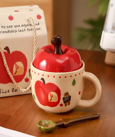 A large apple with a lid in a cup