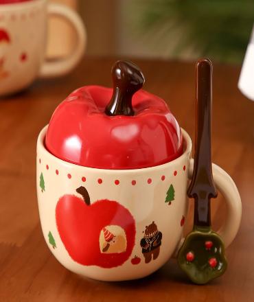 A large apple with a lid in a cup