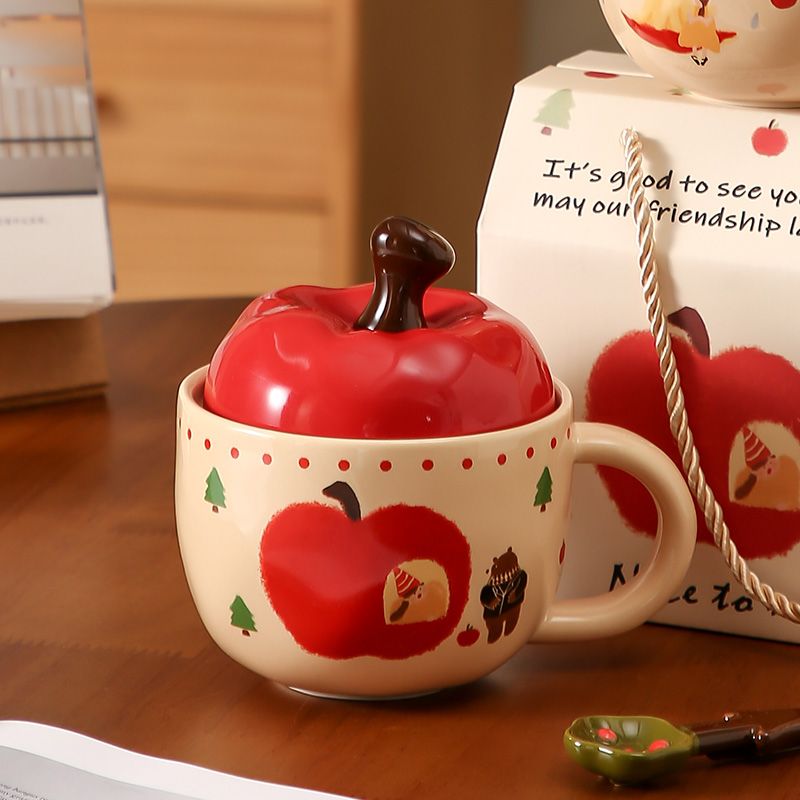 A large apple with a lid in a cup